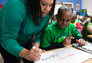 A modern teacher teaching a more casual cursive writing