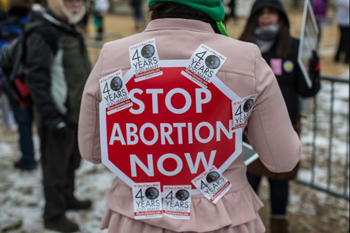 A March for life protestor covered with propoganda