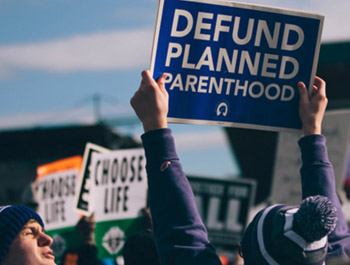 protester holding defund planned parenthood