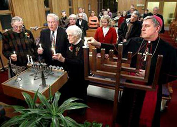 Bishop Listecki lights a menorah