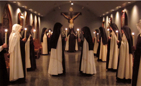 carmelites holding candles for the salve regina