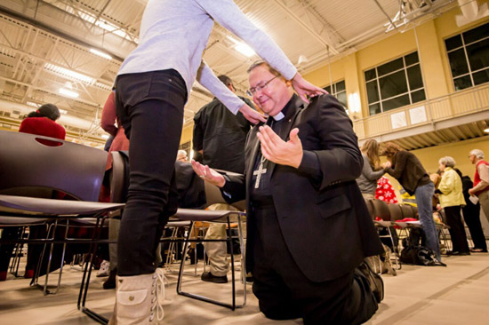 A bishop being blessed by a protestant