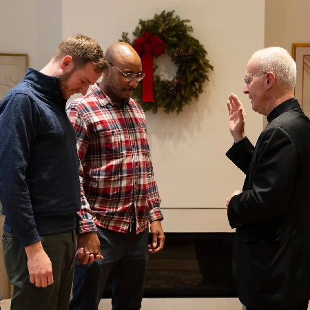 same sex couple receiving blessing