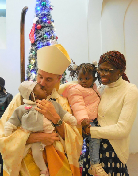 New Cardinal Vesco kissing baby